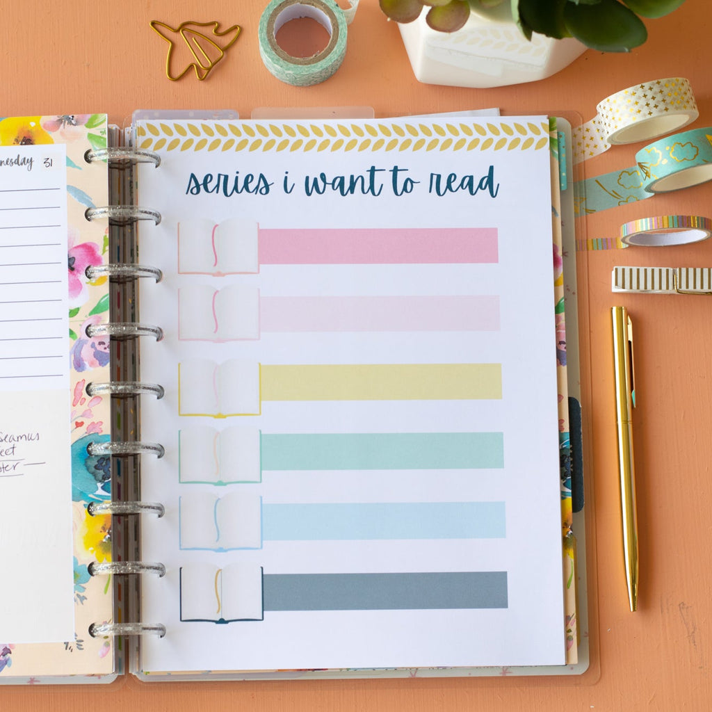 Open planner with colorful tabs on a desk with stationery items