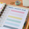 Planner page titled 'series i want to read' with colorful checkboxes on a desk.