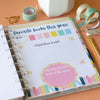 Notebook with a page titled 'Favorite books this year' on a desk with stationery items.